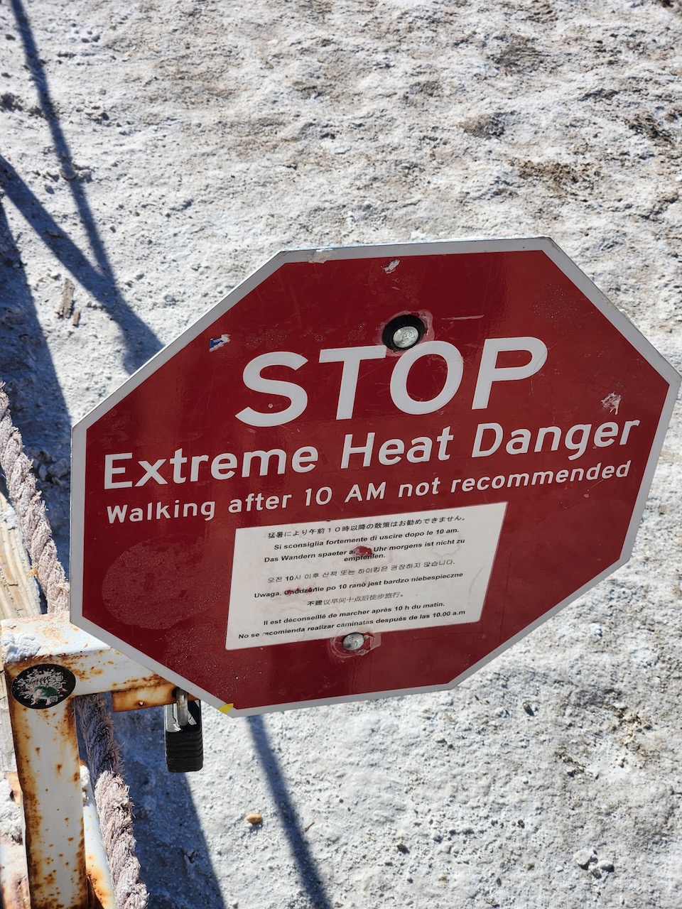 Stop sign that reads STOP EXTREME HEAT ANGER WALKING AFTER 10 AM NOT RECOMMENDED