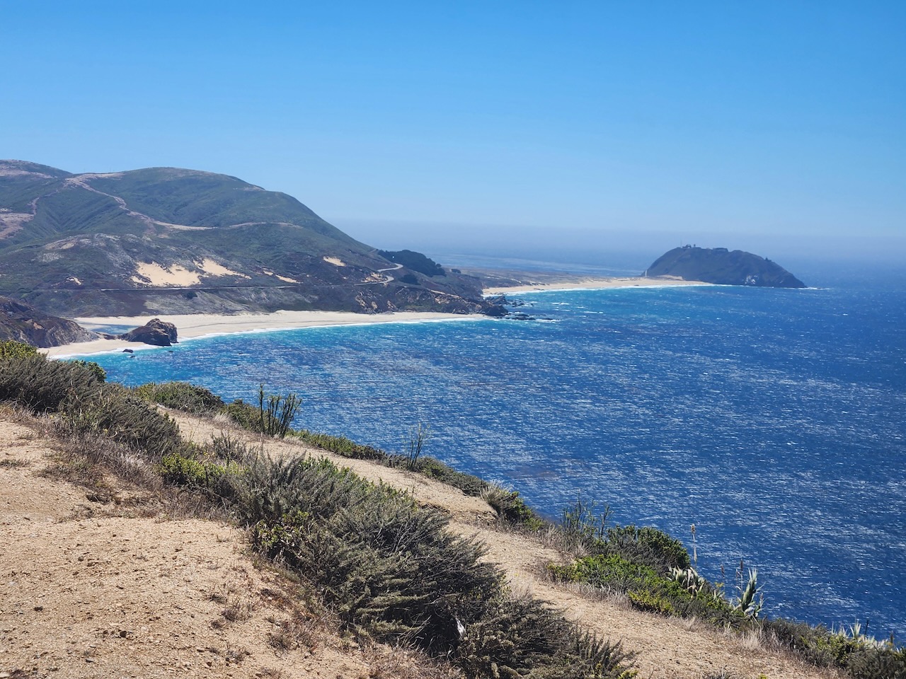 View of Pacific Ocean and cliffs of California along Pacific Coast Highway.