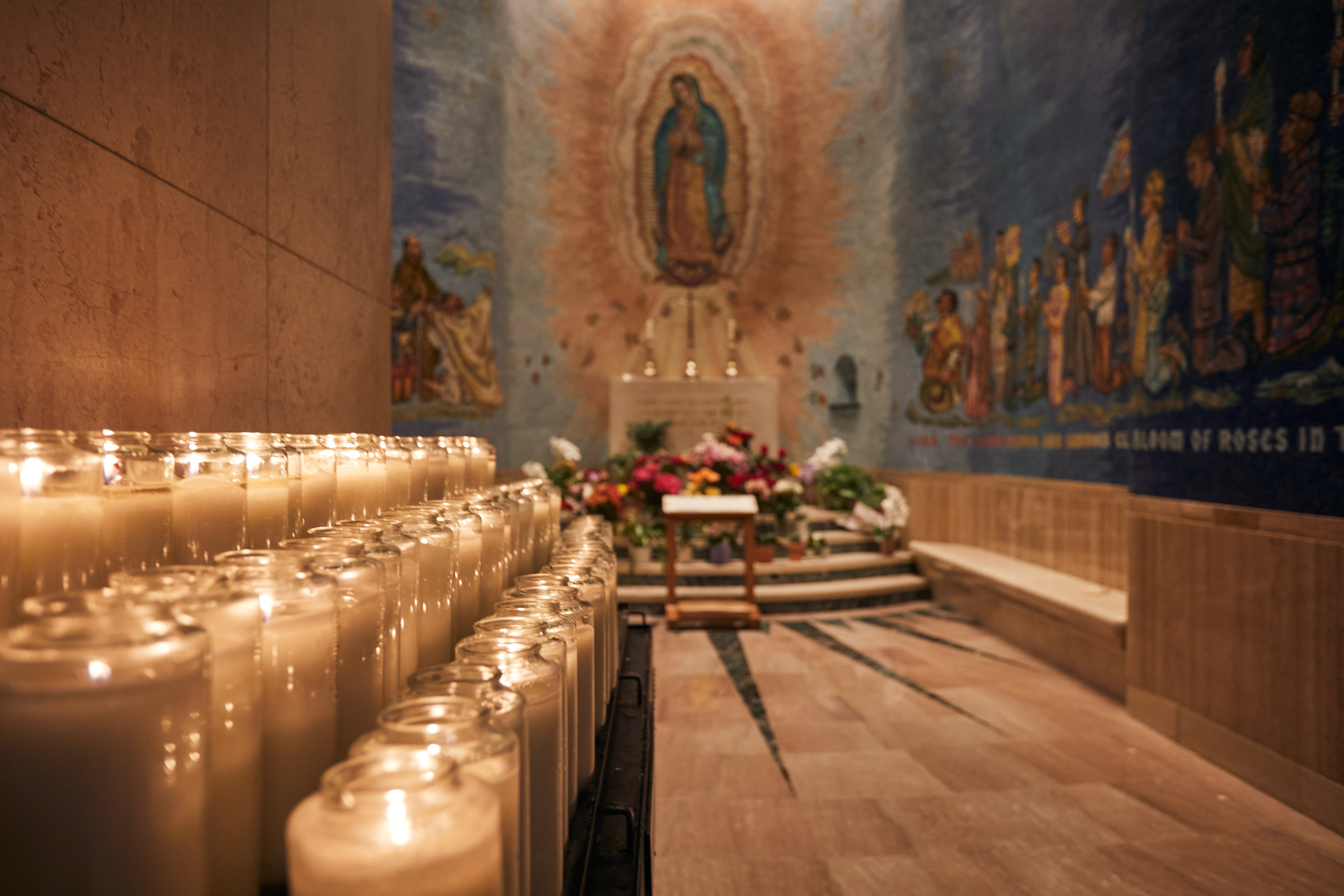 Shrine to Mary with candles in foreground.