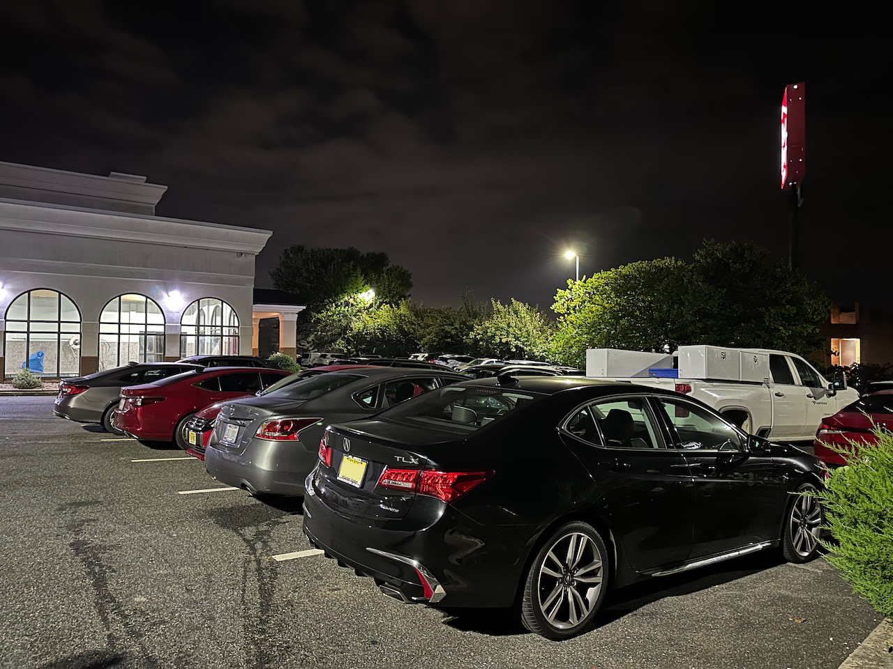 2020 Acura TLX in Holiday Inn parking lot. The hotel is visible in the background.