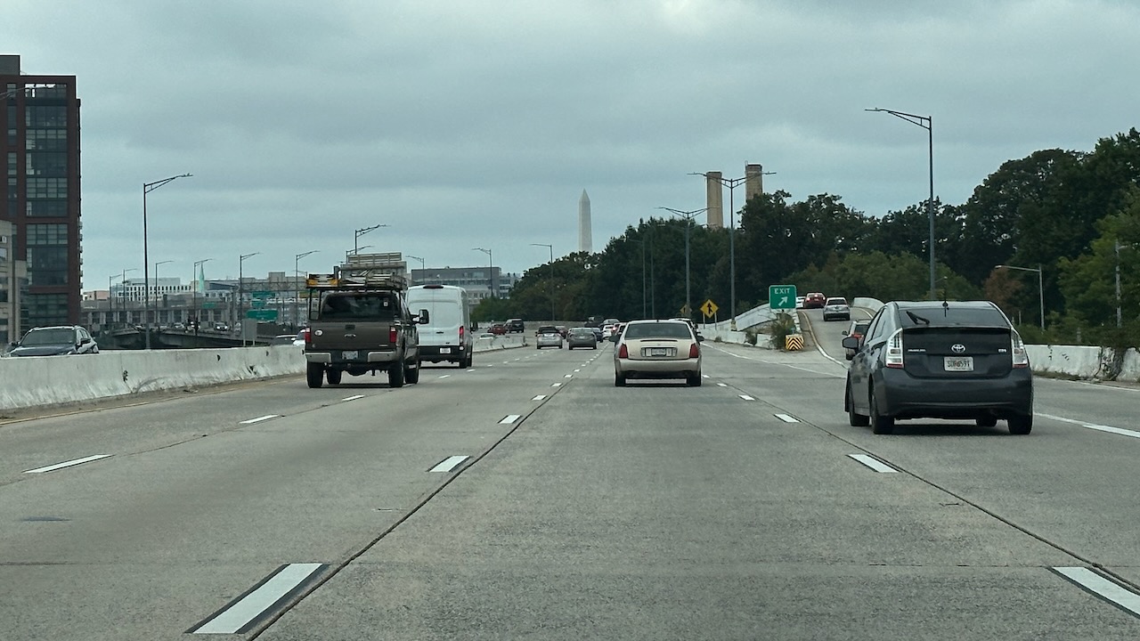 Highway with Washington Monument in distance.
