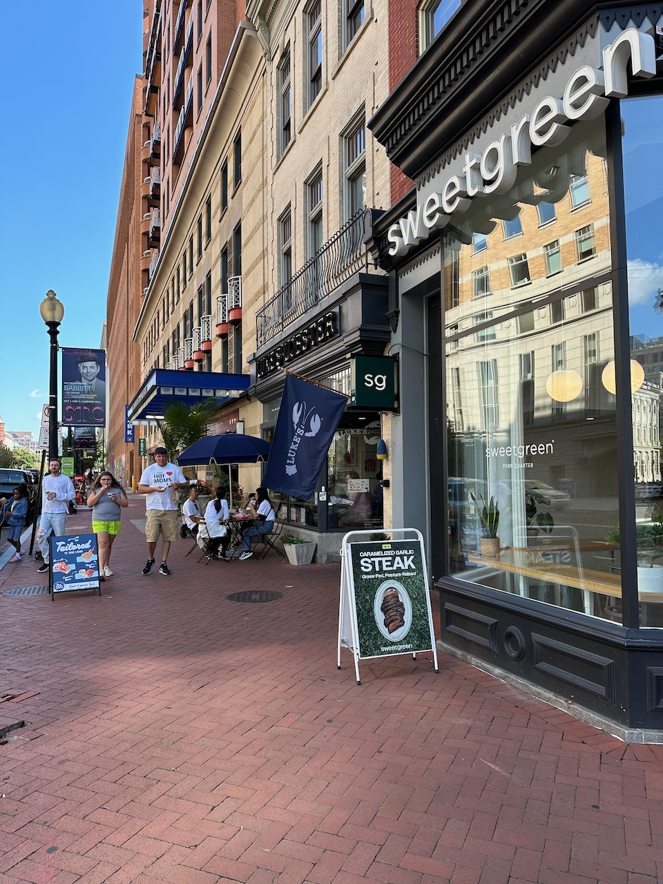 Exterior of row of buildings, with two restaurants in foreground.