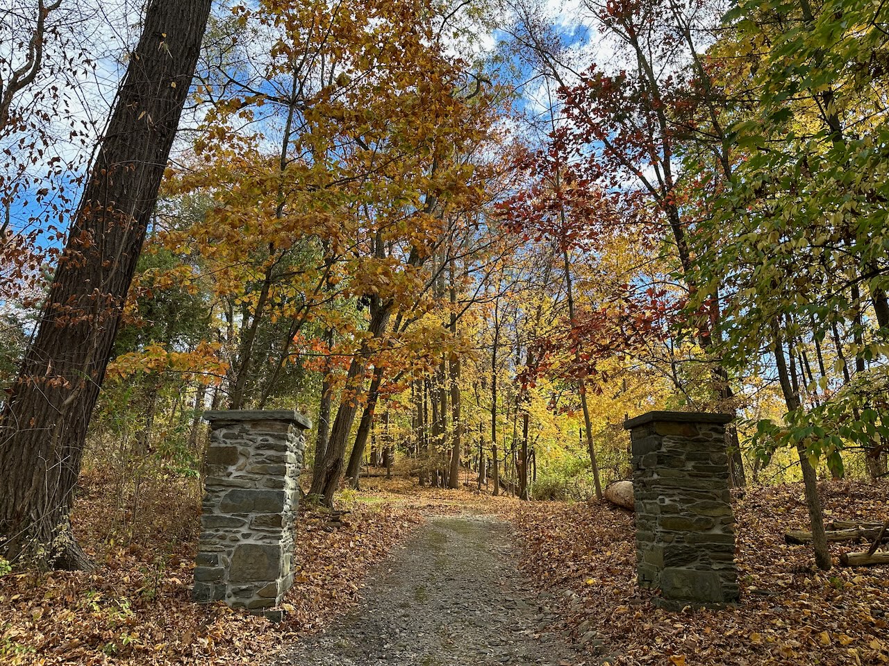 Two stone piers on either side of lane.