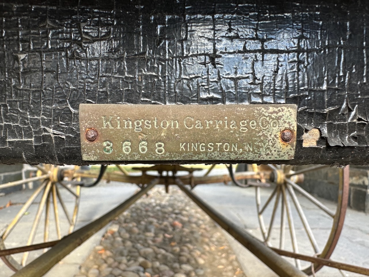 Bronze plaque on back of horse-drawn carriage.