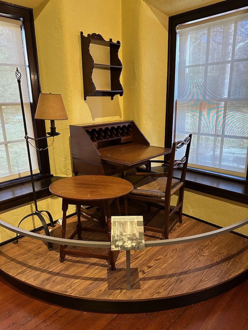 Desk, table, lamp, and shelves on display.