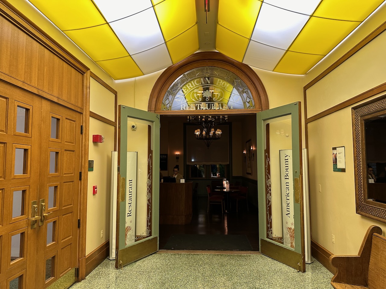 Entrance to American Bounty Restaurant in building hallway.