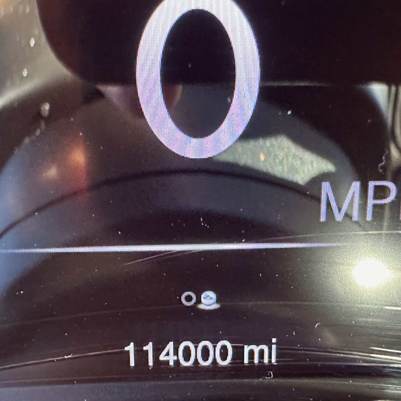 Car odometer reading 114000 miles.