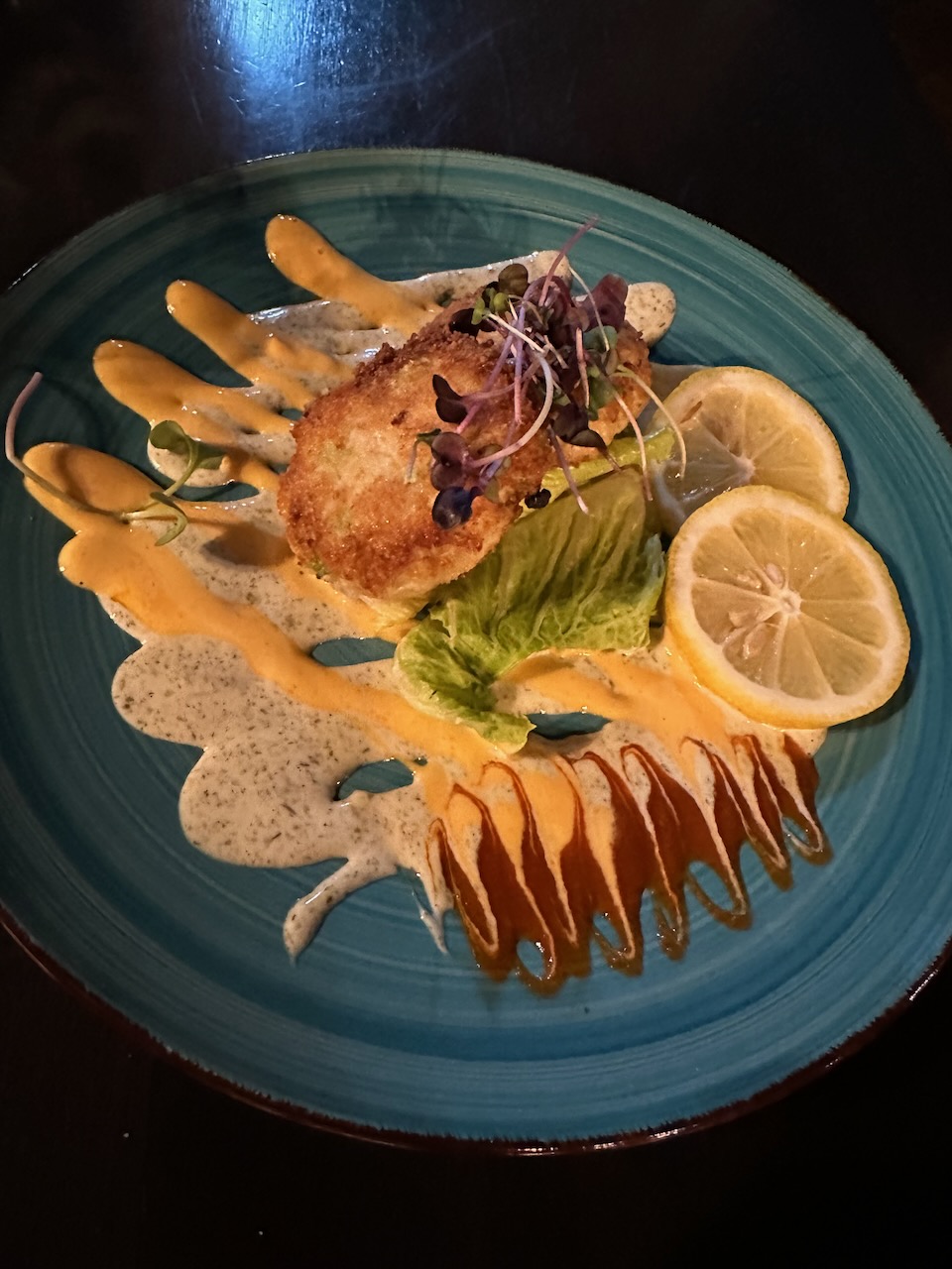 Shrimp and crab cakes on blue plate.