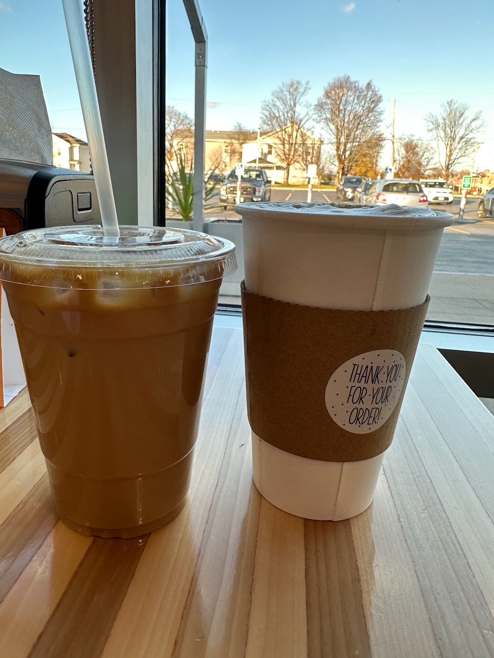 Iced coffee (left) and hot coffee in white cup (right).