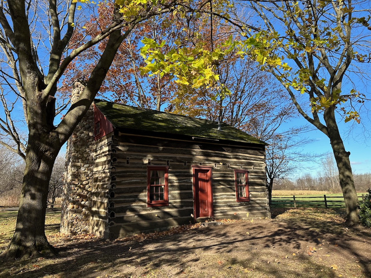 Peter Whitmer Log Cabin surrounded by trees.