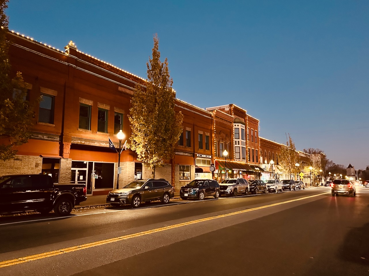 Downtown Seneca Falls, lit up at dusk.