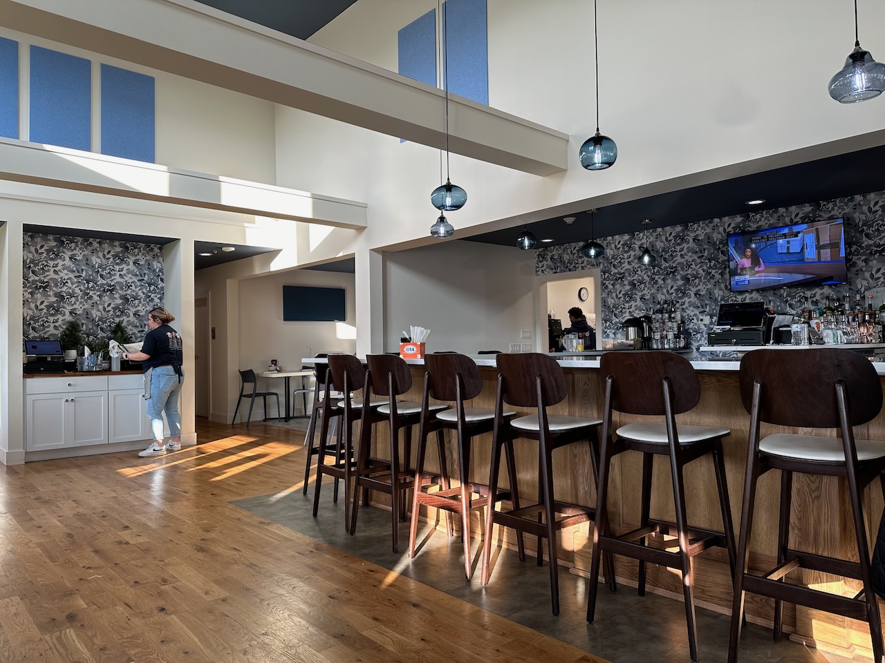 Interior of At Long Last cafe, with view toward bar and dining area.
