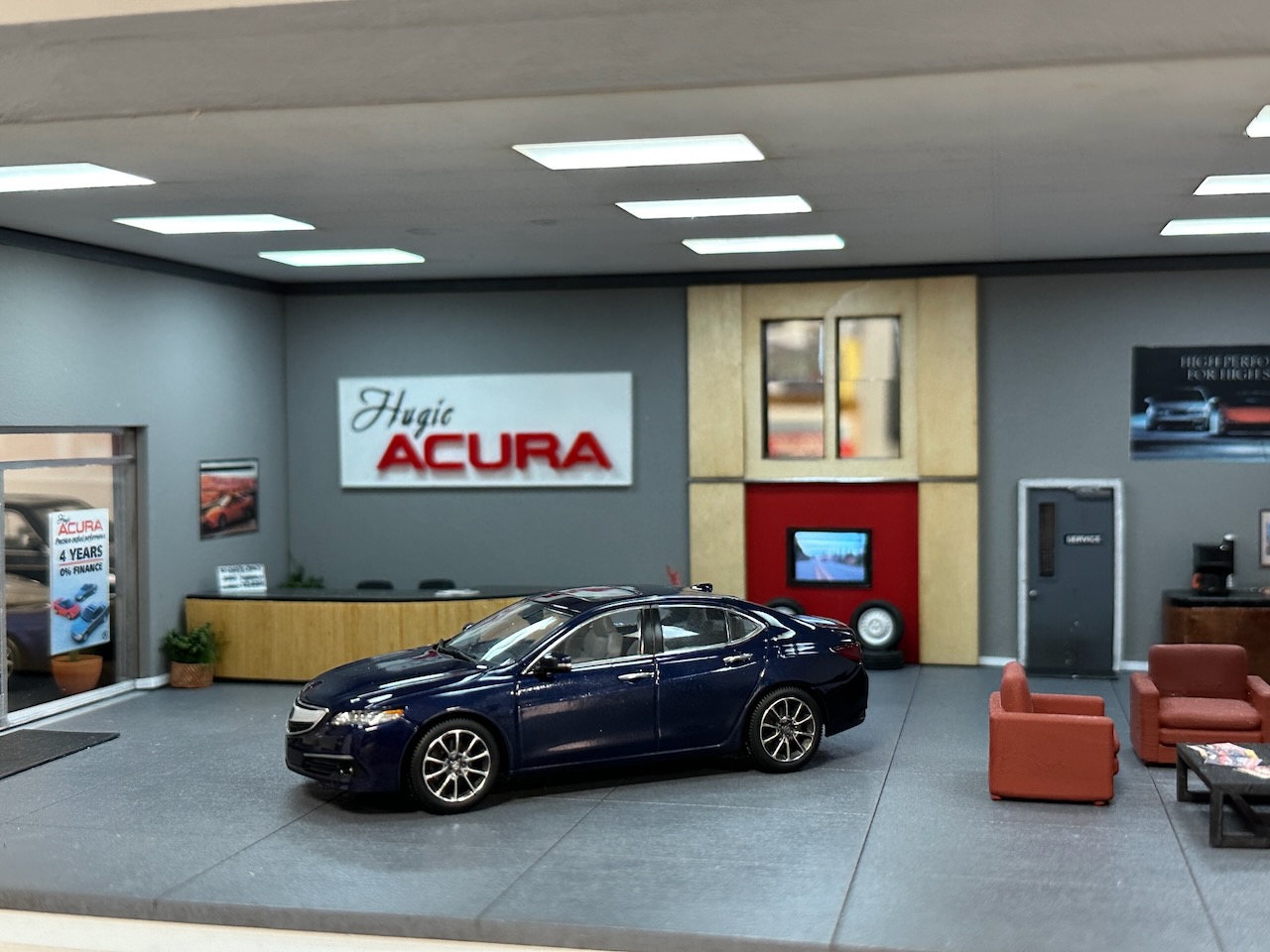 Acura TLX model on showroom floor of Acura dealership.