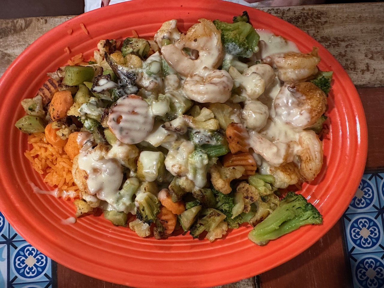 Platter of shrimp, rice, potatoes, and vegetables.