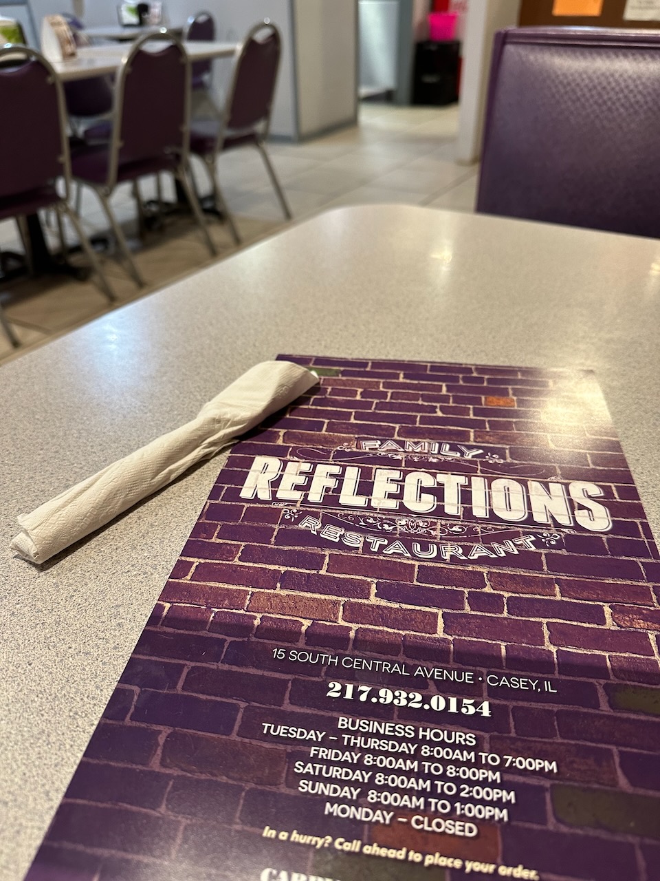 Menu of and napkin on diner table.