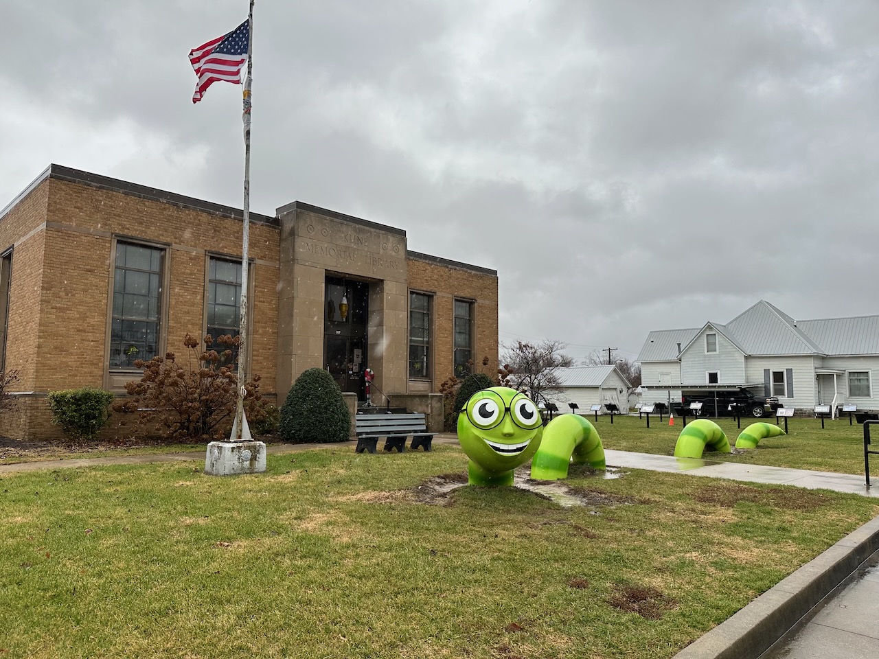 Fanciful bookworm sculpture outside of library.