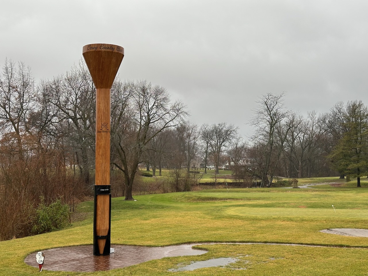 World's Largest Golf Tee at edge of golf course green.