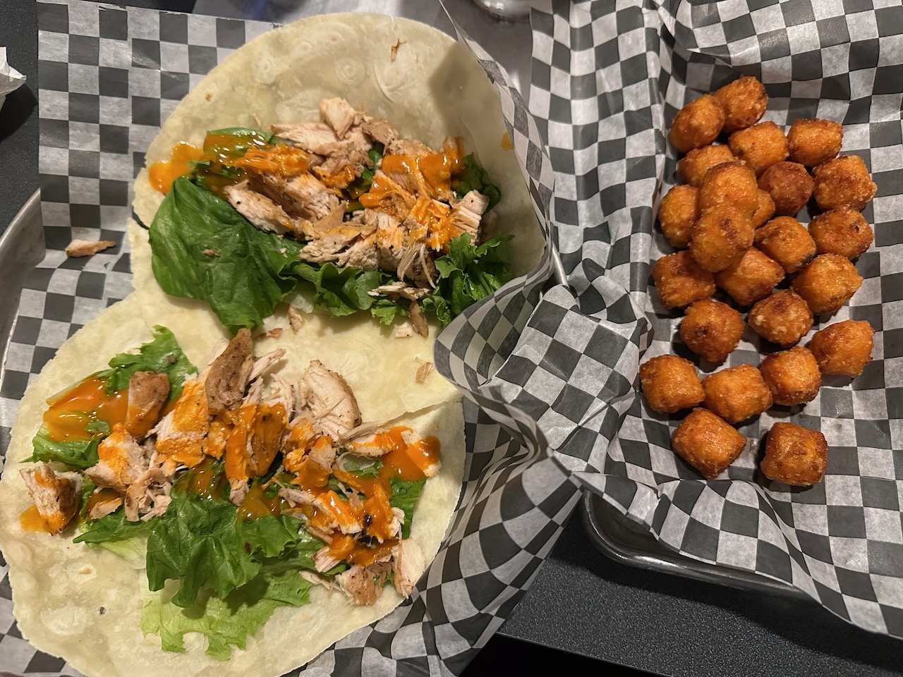 Shredded turkey, mayo, peach bourbon BBQ sauce, lettuce and tomato on two wraps, with a side order of tater tots.