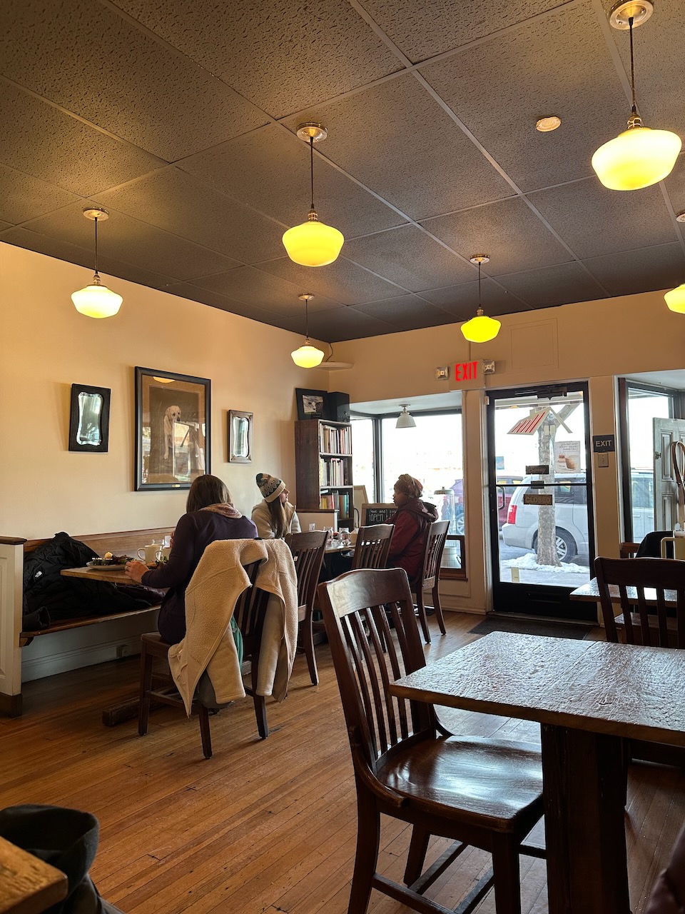 Interior of Farmhouse Kitchen cafe, with several small tables in dining room. 