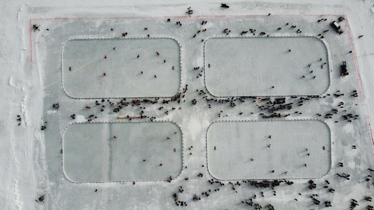 Aerial view of four rinks on lake.