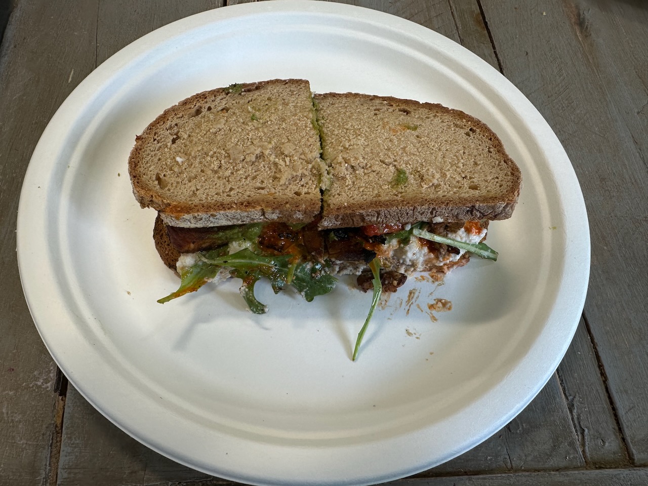 973 sandwich on white paper plate. 