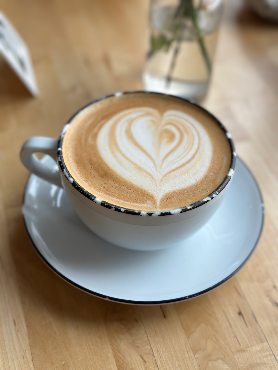 Oat milk latte in white cup. 