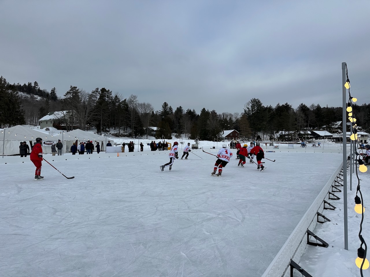 View of ice rink with two teams playing. 