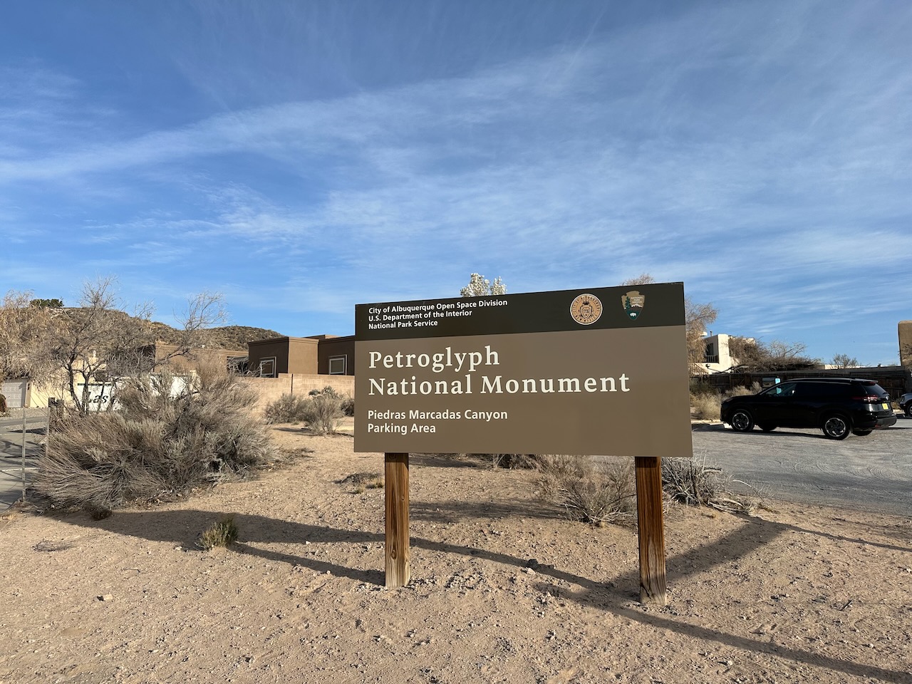 Trailhead with sign for Piedras Maracas Canyon of Petroglyph National Monument. 