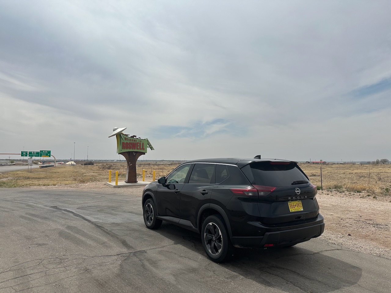 2025 Nissan Rogue parked in front of Roswell sign. 