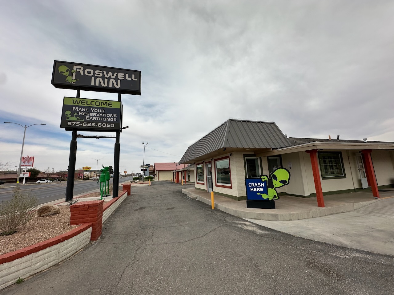 Exterior of Roswell Inn with alien welcome sign by front door. 