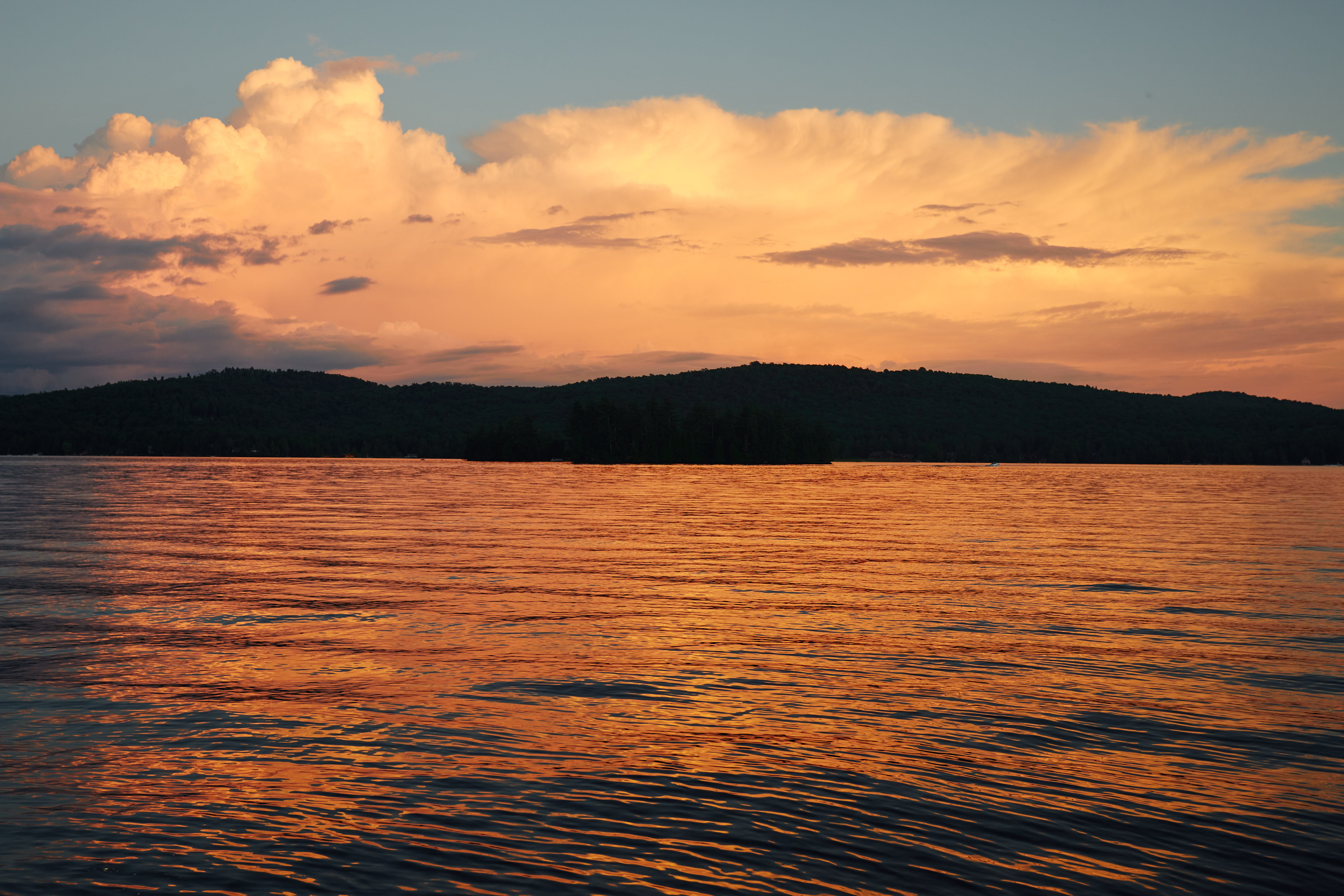 Sunset over Fourth Lake, with mountains in background. 