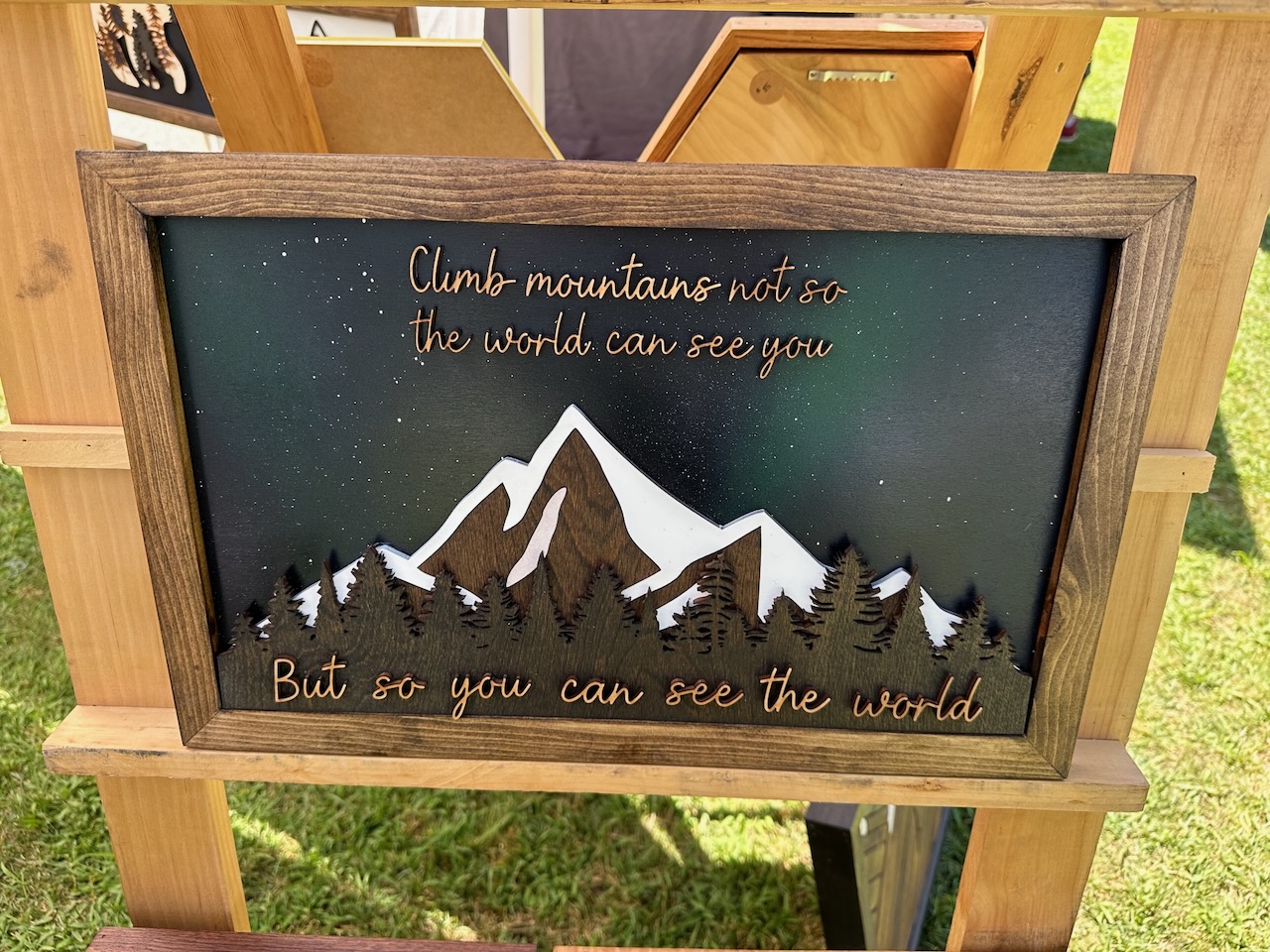 Woodcut art of mountains with words CLIMB MOUNTAINS NOT SO THE WORLD CAN SEE YOU BUT SO YOU CAN SEE THE WORLD. 