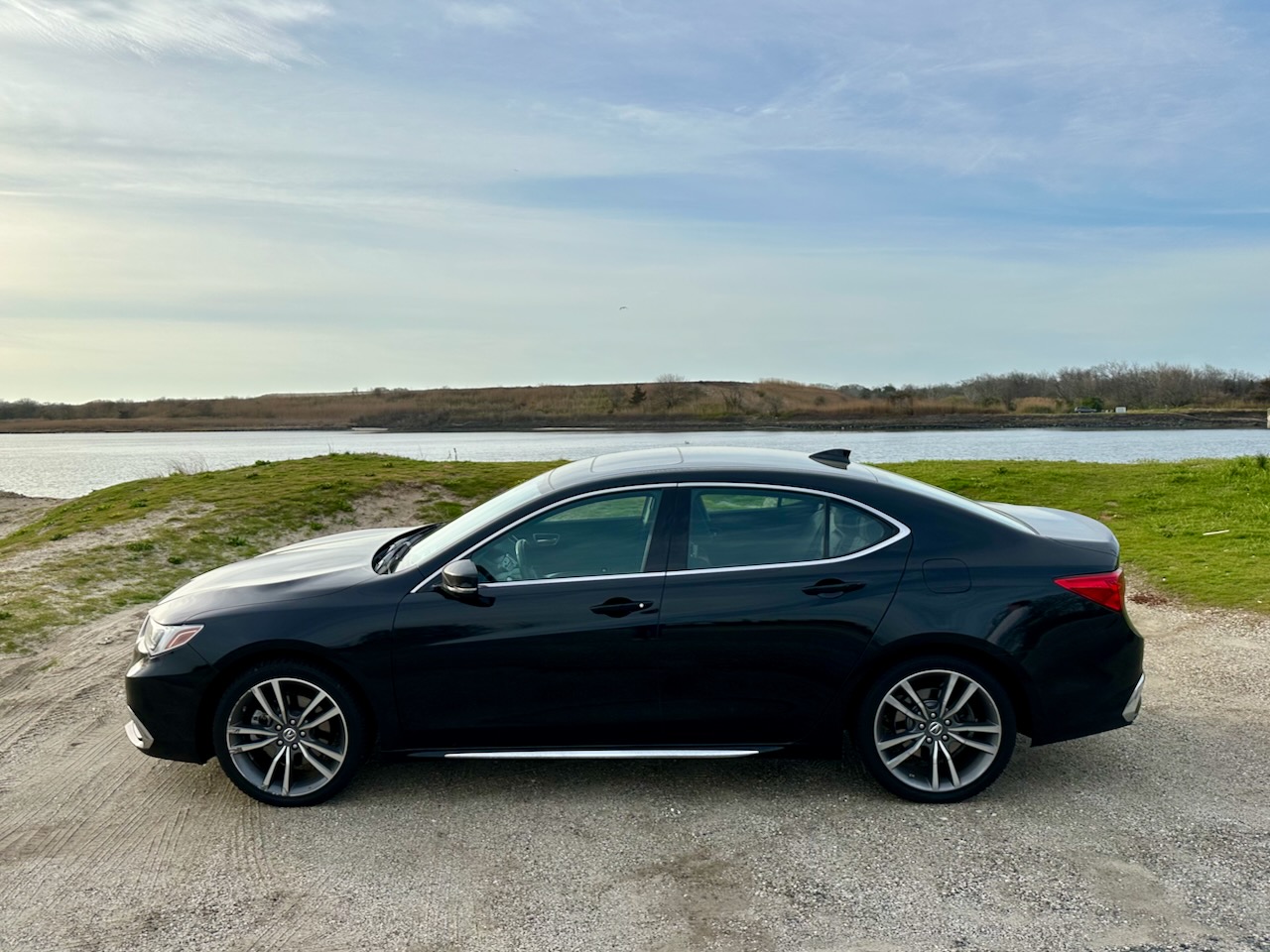 2020 Acura TLX parked beside shipping channel for Cape May-Lewes Ferry. 