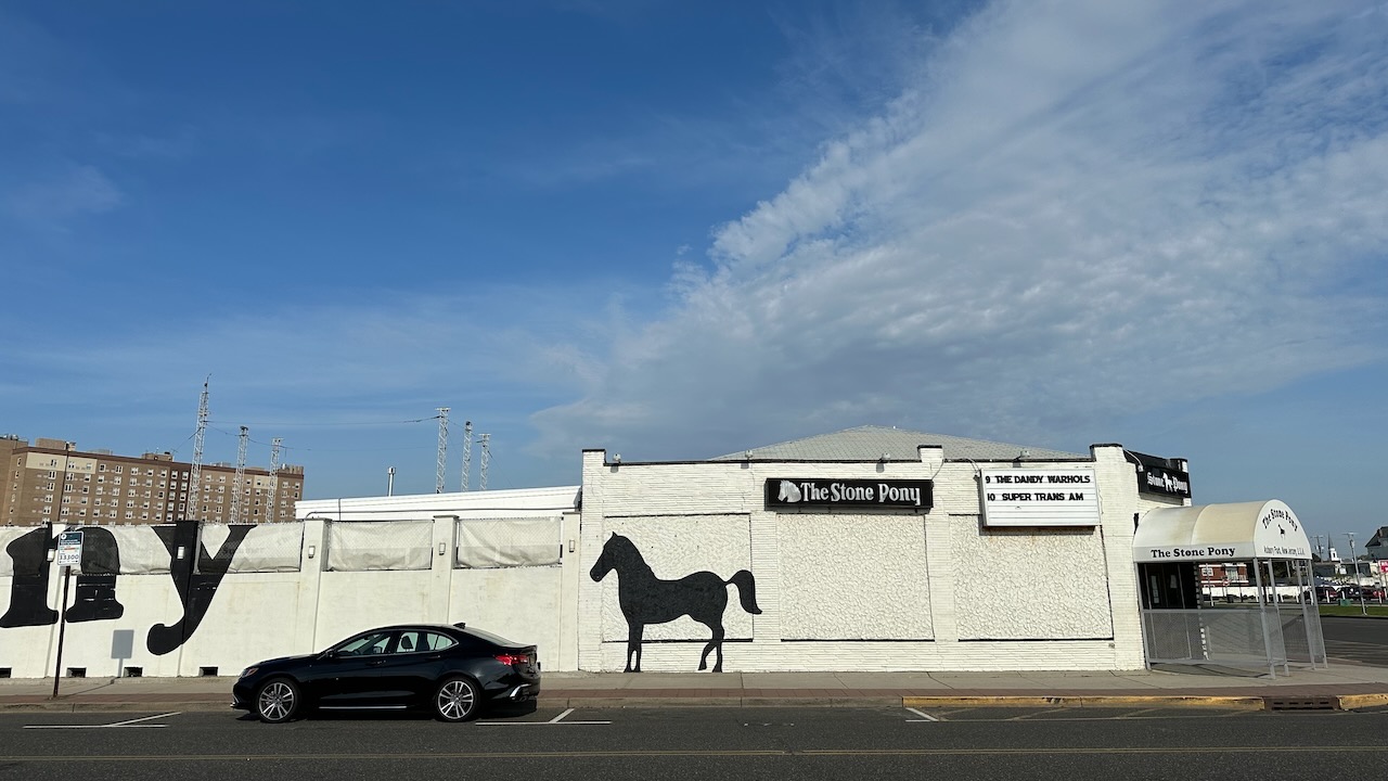 Acura TLX parked in front of The Stone Pony concert venue. 
