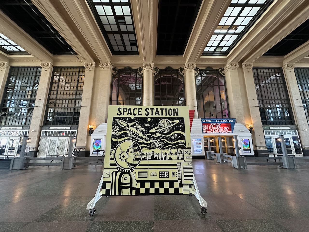 Interior of Asbury Park Convention Hall, with a mural in foreground. 