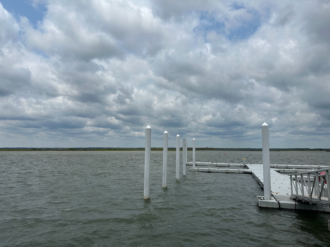 View of bay, with docks in foreground. 