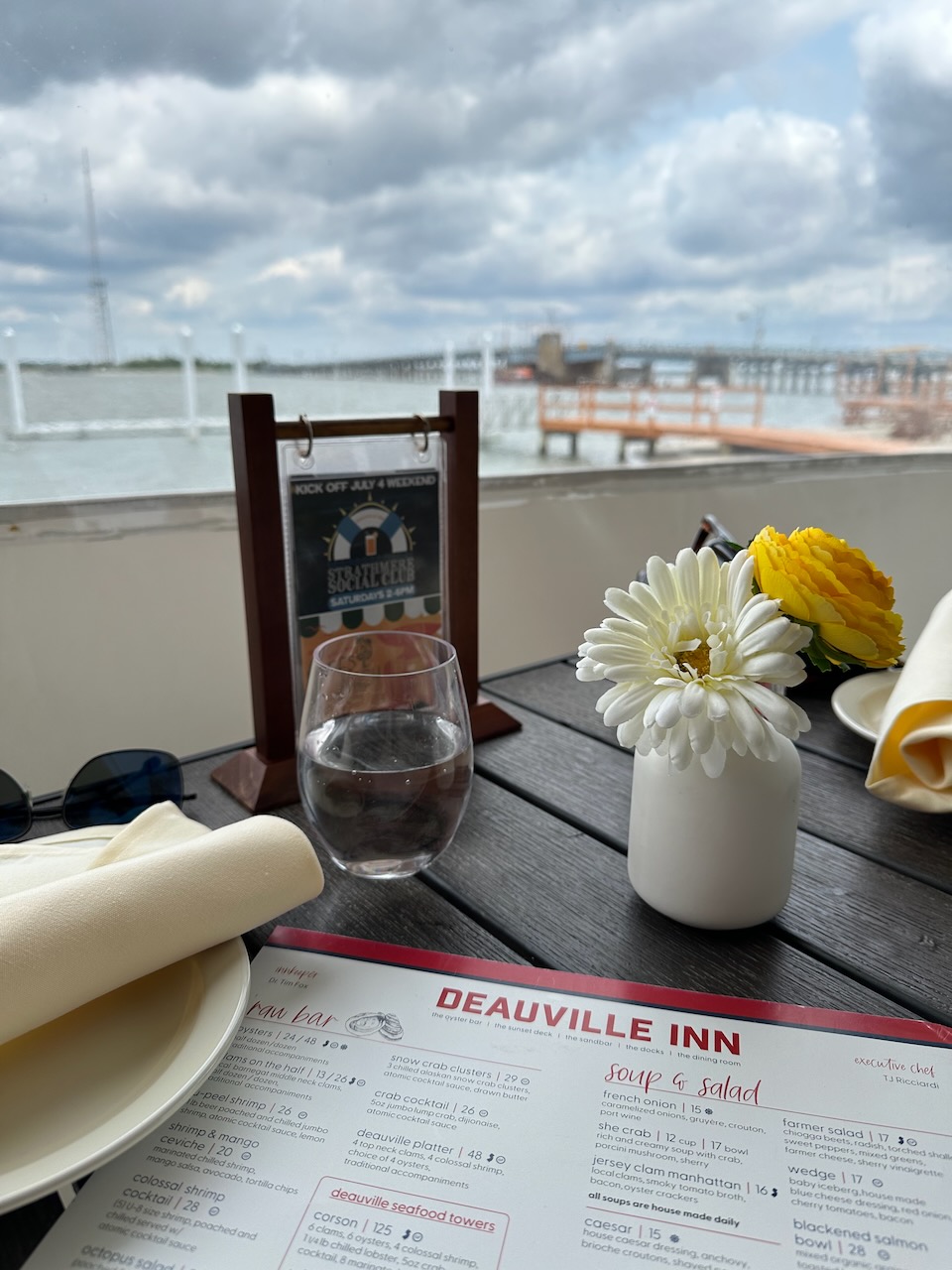 Menu for Deauville Inn on table overlooking bay and wetlands. 