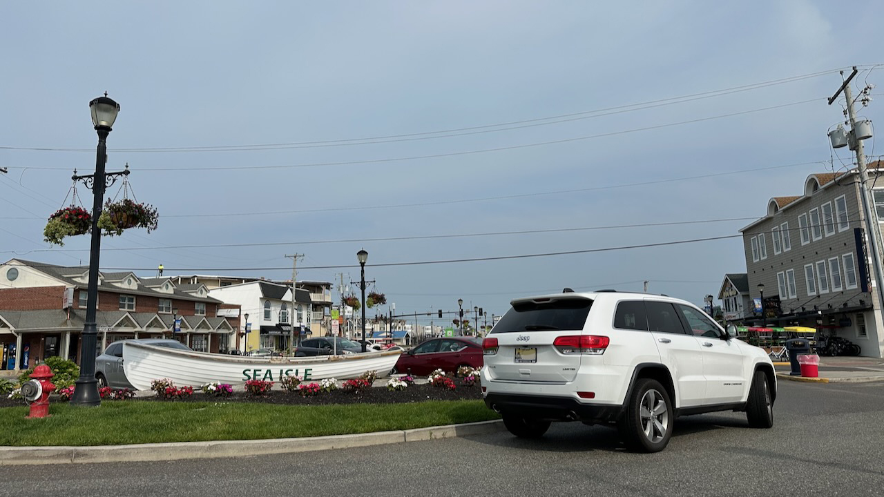 2014 Jeep Grand Cherokee parked in front of Lifeboat with words SEA ISLE on side in downtown. 