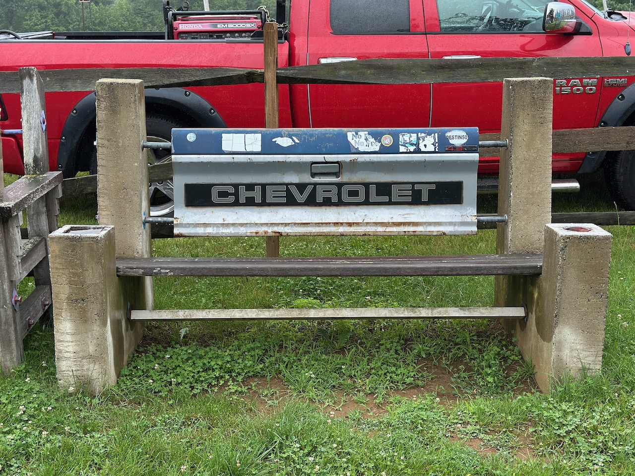 Bench with pickup truck tailgate as backrest.