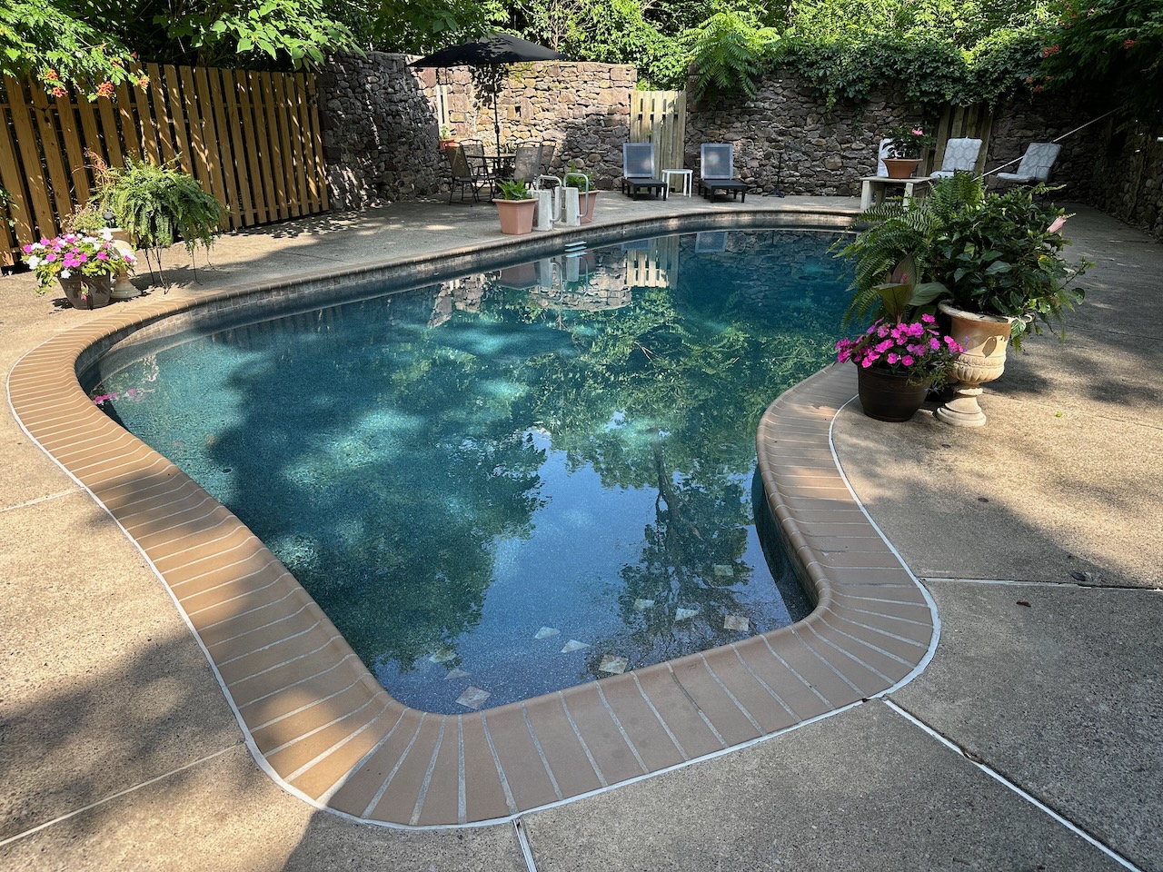 Pool and surrounding patio at Pineapple Hill Inn. 