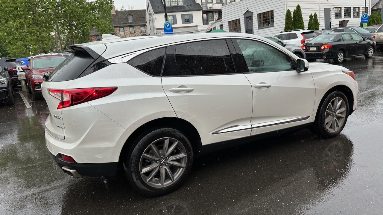 2019+ Acura RDX SUV in parking lot. The ground is wet. 