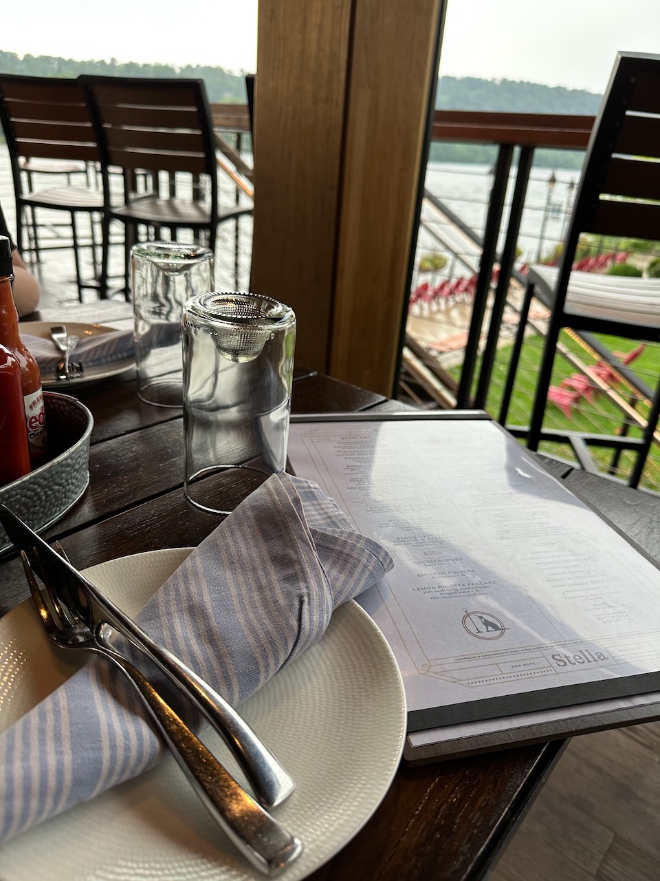 Menu and plates on patio table. 