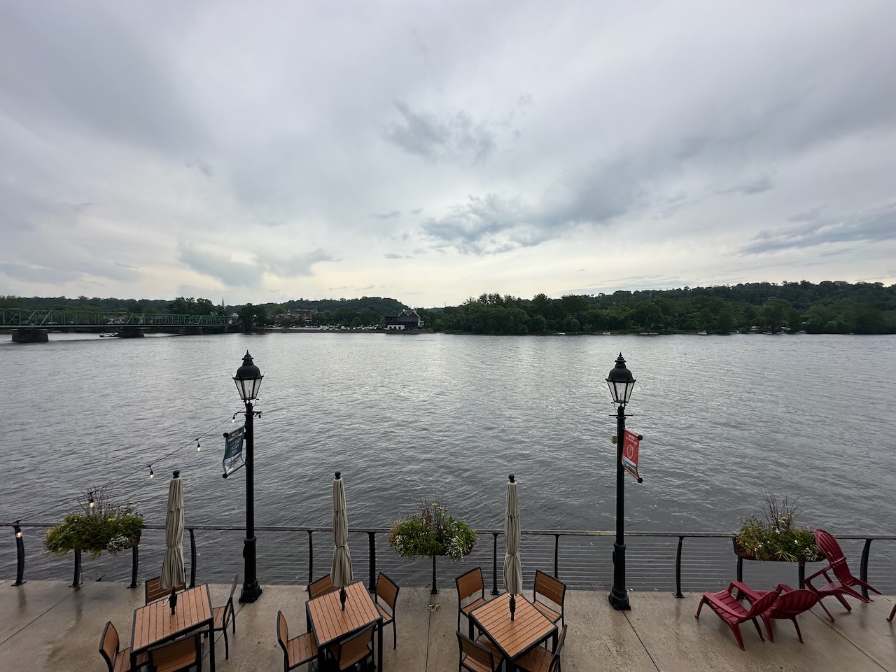 View of lower patio of restaurant and Delaware River, with New Jersey shoreline in distance. 