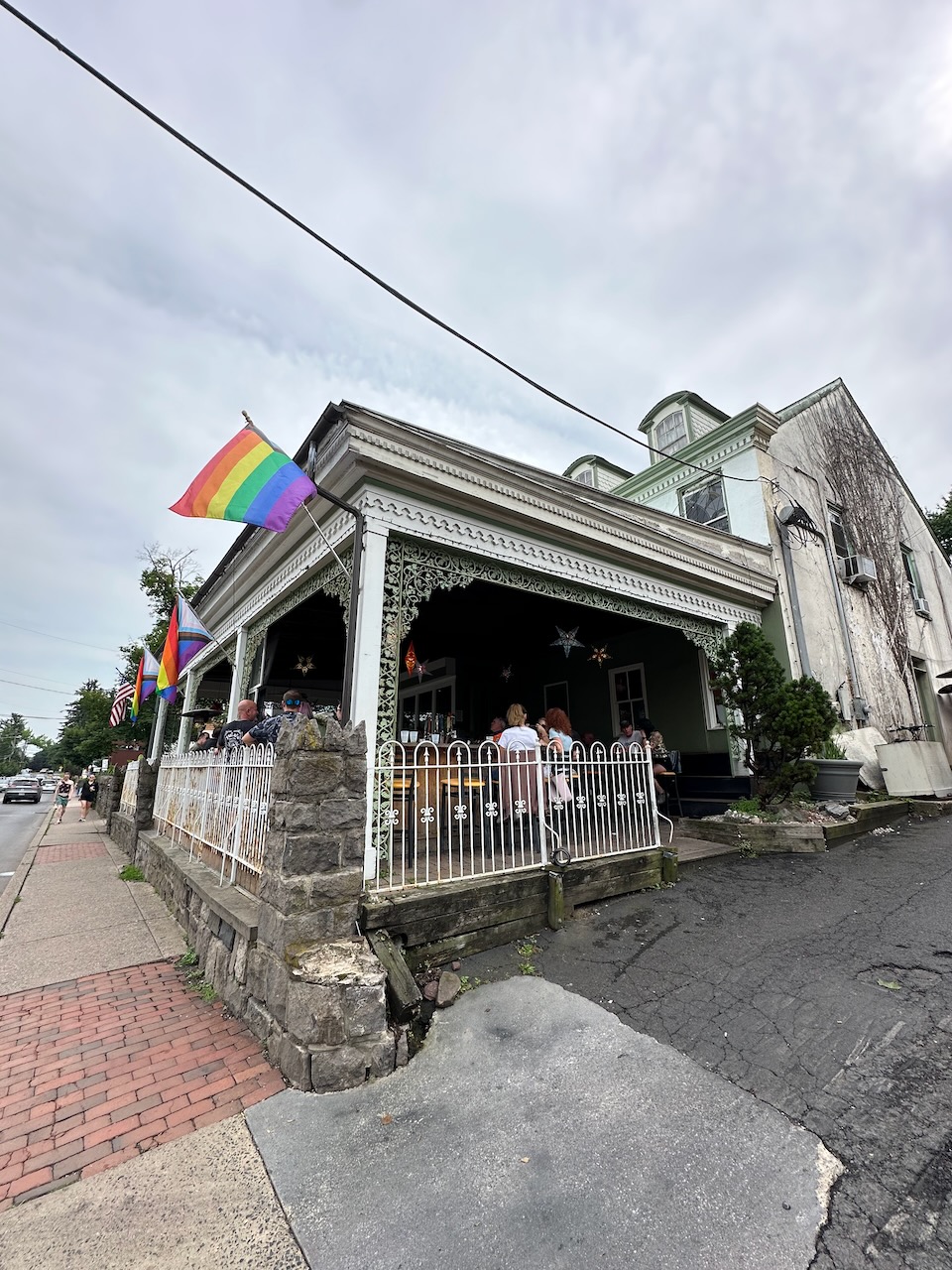 Havana patio bar with pride flag flying from porch. 
