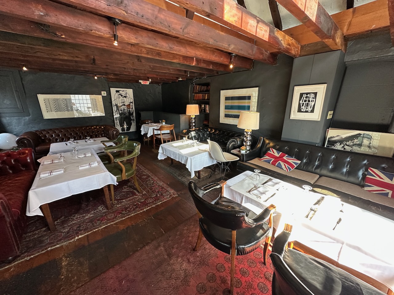 Top floor of Salt House with several tables and chairs, and all tables are covered with white tablecloths. 