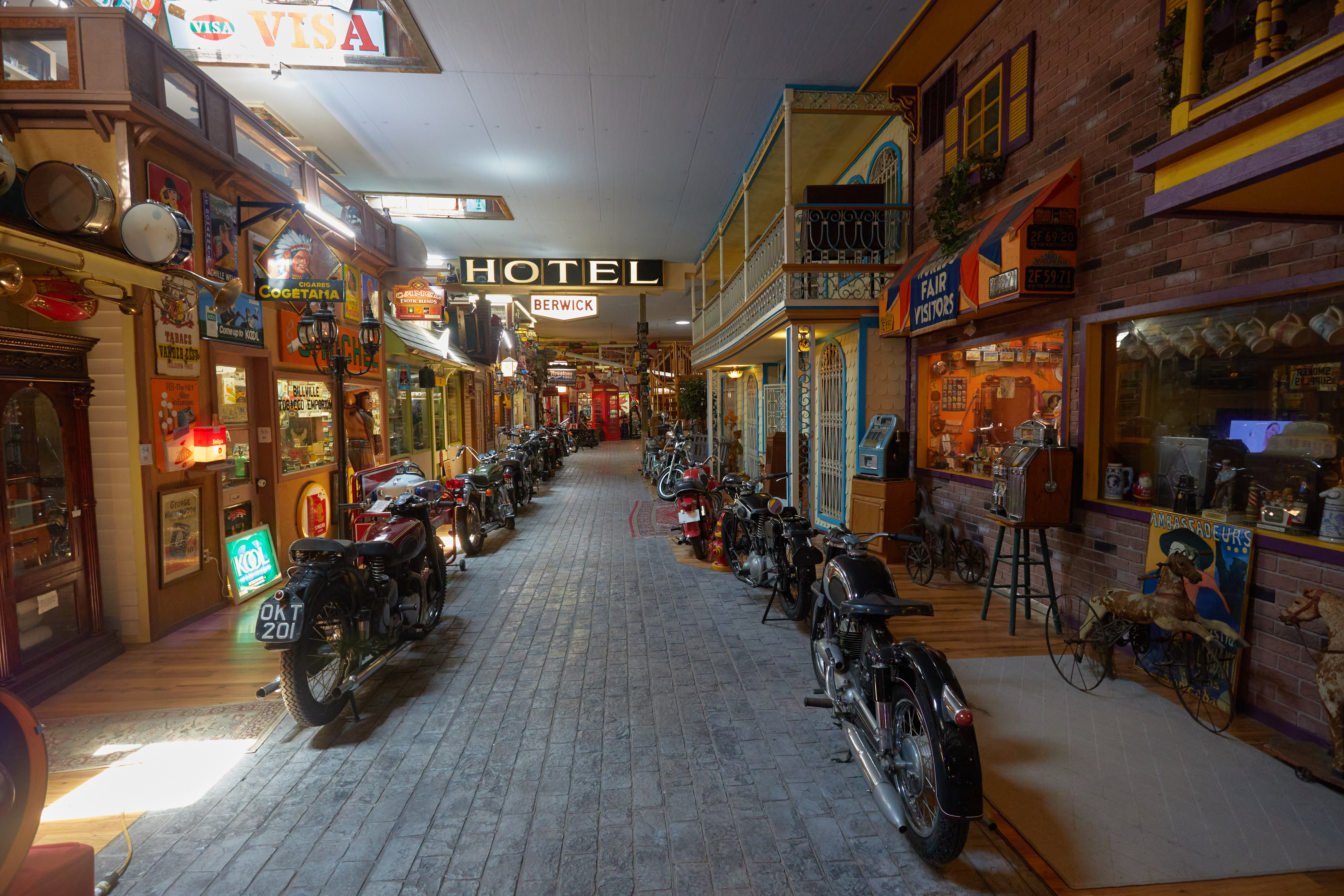 Reproduced main street of town within museum, with storefronts on either side of walkway.