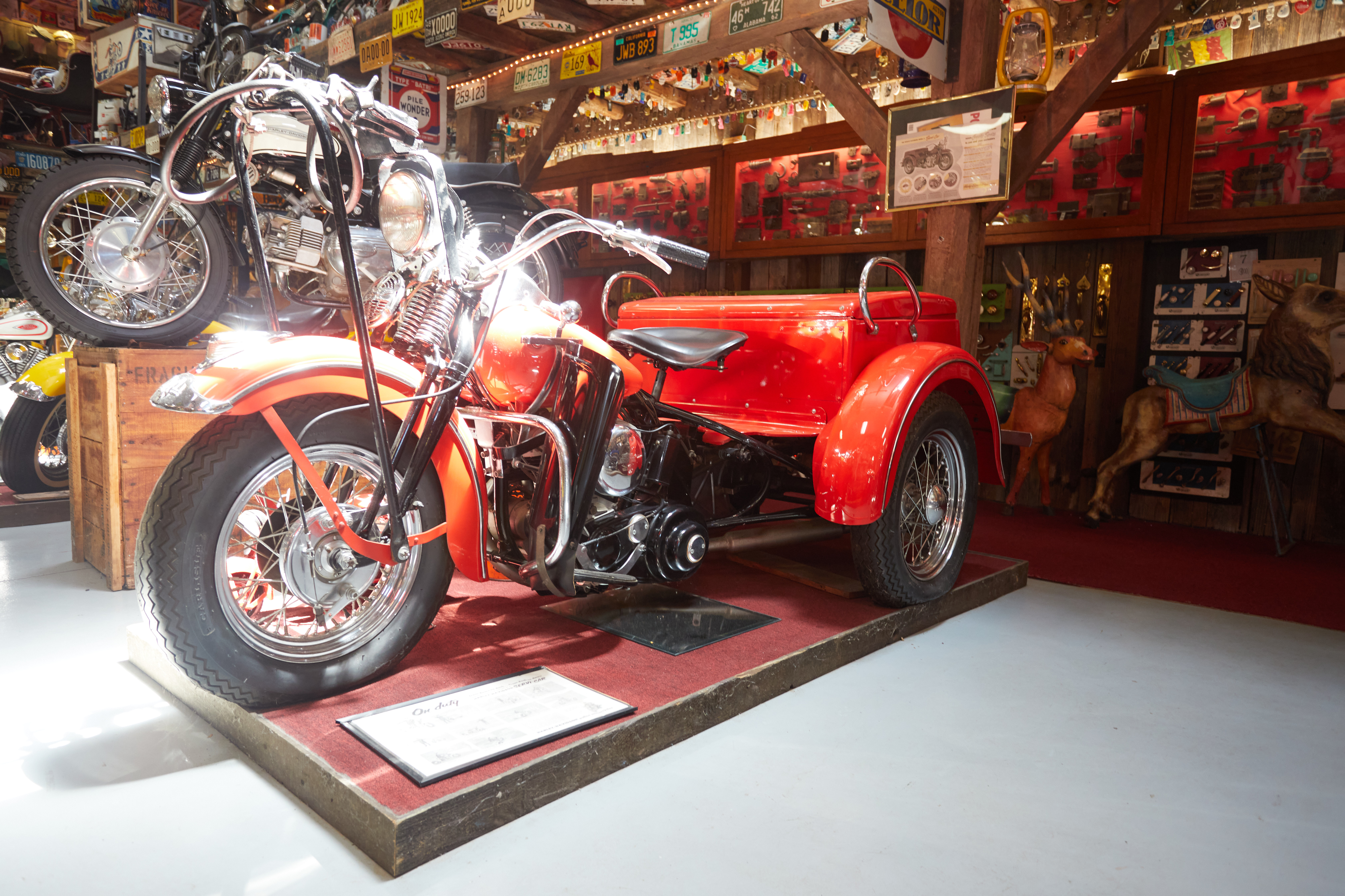 Red Harley-Davidson Servi-Car on pedestal.