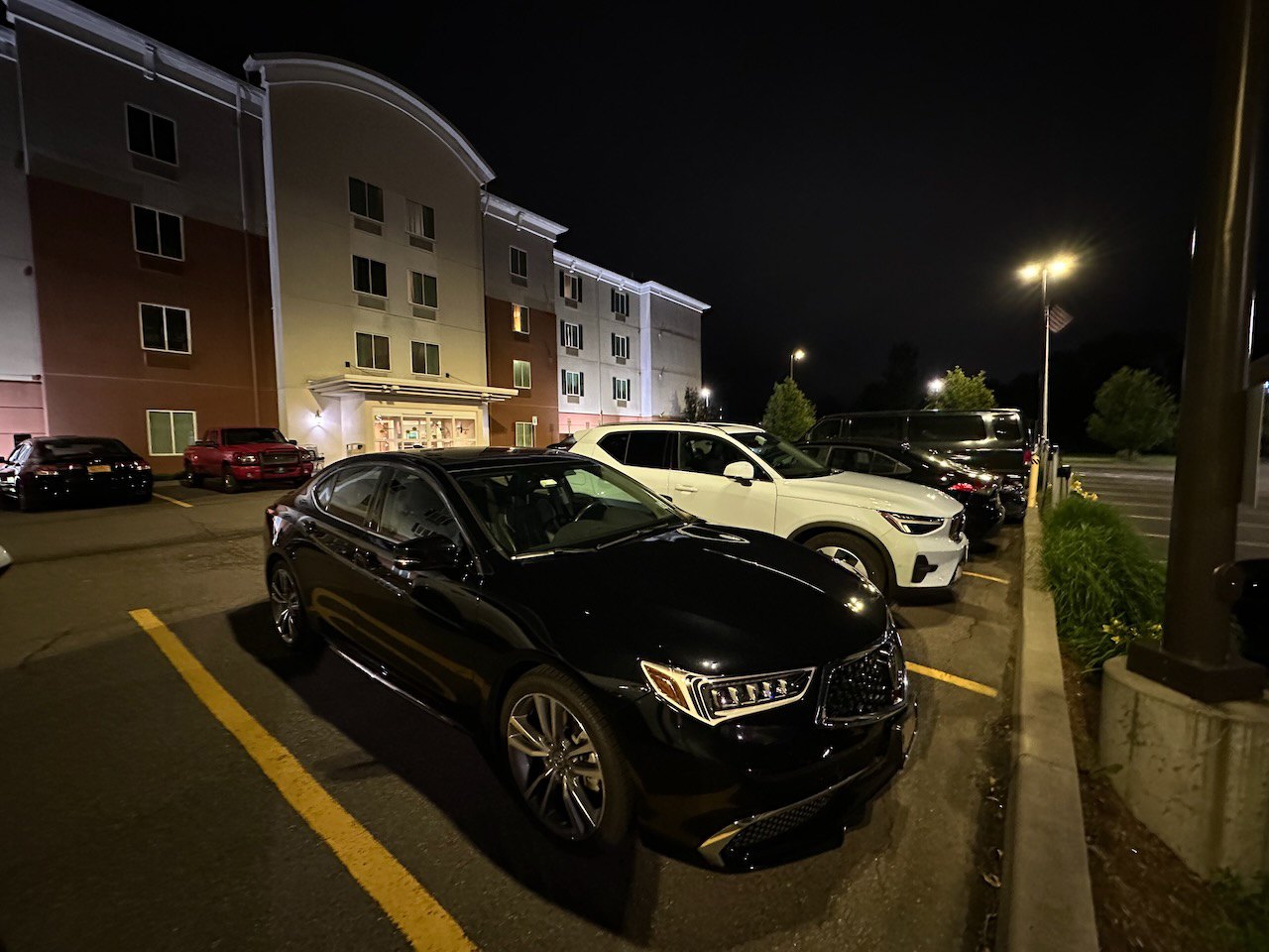 2020 Acura TLX parked in hotel parking lot. 