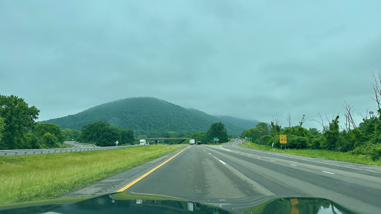 View of I-86 with mist covering mountains in distance. 