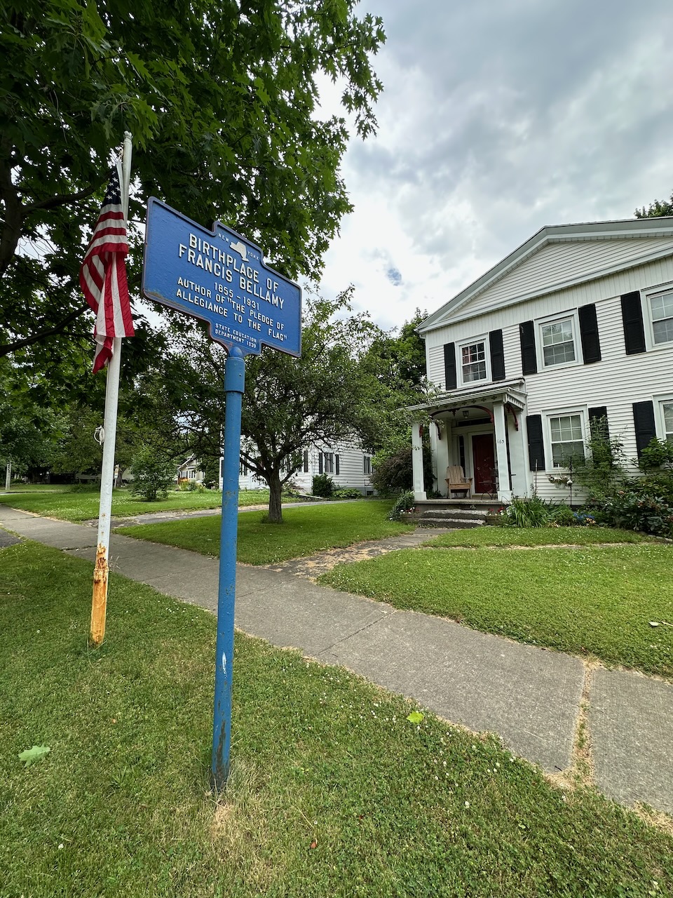 Exterior of Francis Bellamy Home with a blue sign that reads BIRTH PLACE OF FRANCIS BELLAMY. 